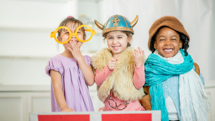 Three children play in costumes during a Kaleidoscope Class.